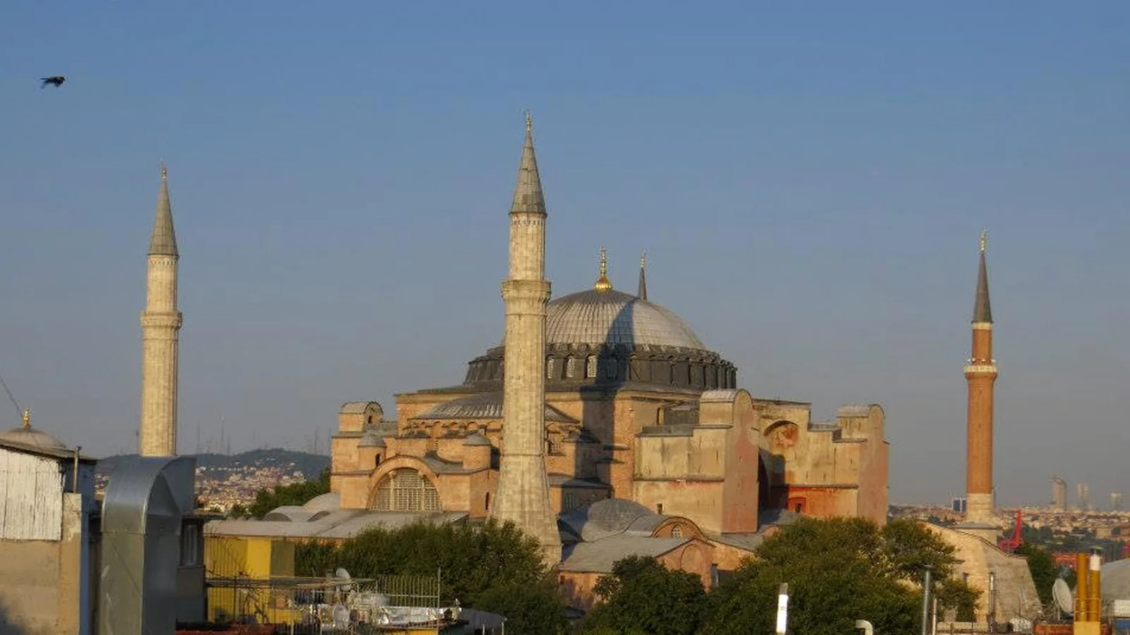 Hagia Sophia and surrounding Istanbul rooftops in warm low-angle light