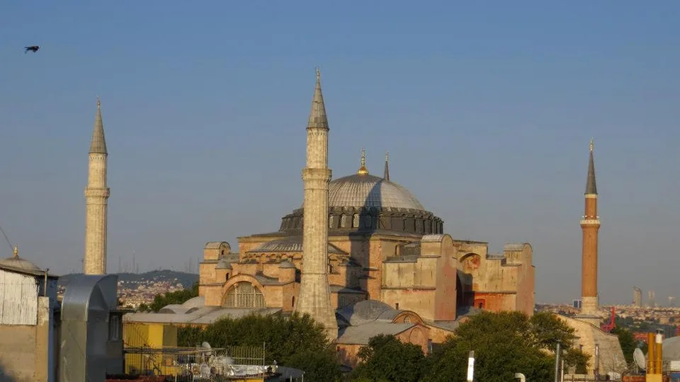 Hagia Sophia and surrounding Istanbul rooftops in warm low-angle light