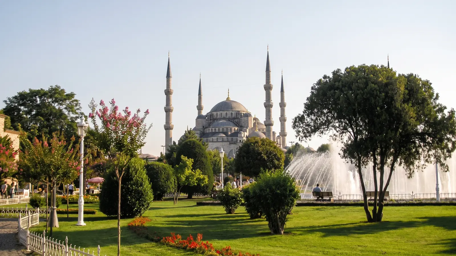 Blue Mosque exterior behind trees and a fountain in Sultanahmet Park