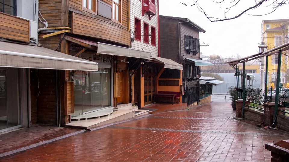 Rain-wet historic Sultanahmet street with wooden facades
