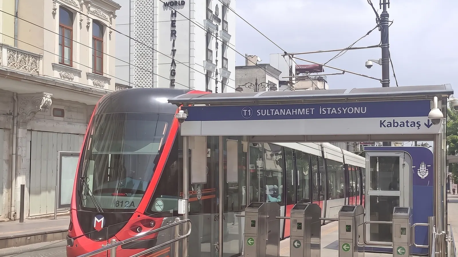 Red T1 tram at Sultanahmet station with the station sign visible
