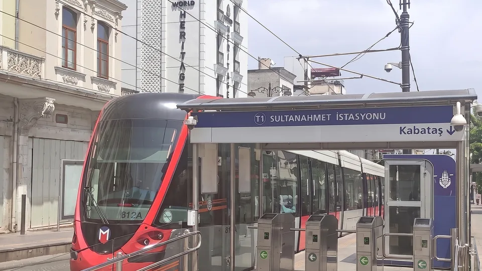 Red T1 tram at Sultanahmet station with the station sign visible