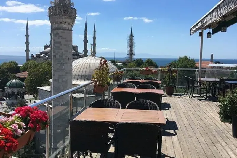 Open terrace tables with the Blue Mosque and sea beyond