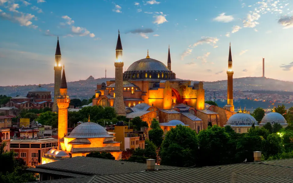 Hagia Sophia floodlit at dusk, minarets against the darkening sky